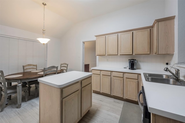 kitchen featuring lofted ceiling, sink, tasteful backsplash, decorative light fixtures, and a center island