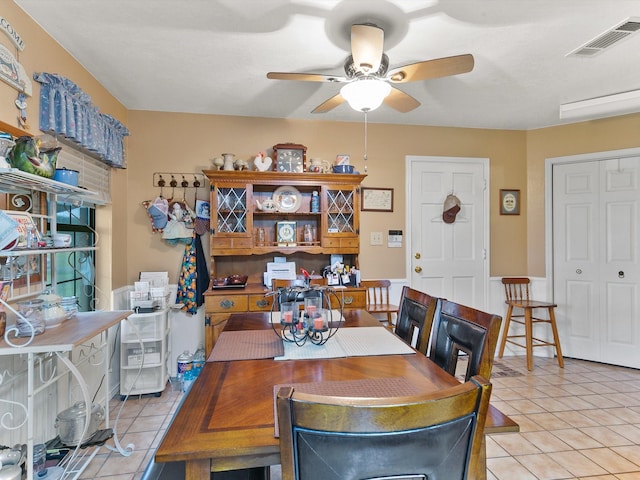 tiled dining room with ceiling fan