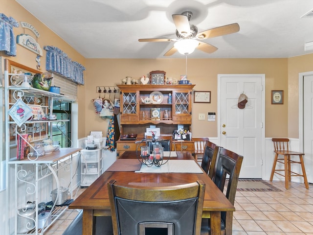 dining area featuring ceiling fan and light tile patterned floors