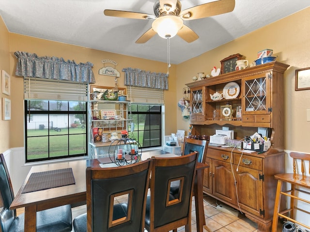 dining space featuring ceiling fan and light tile patterned flooring