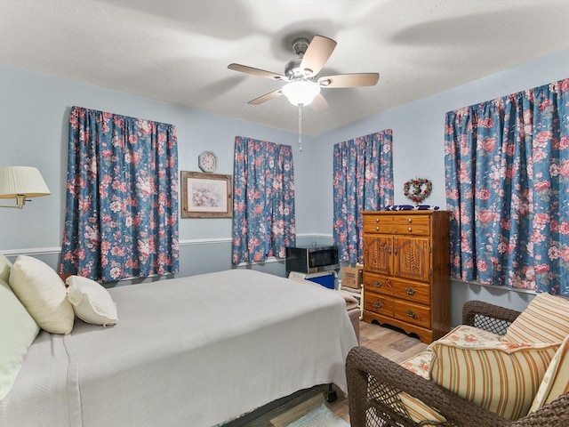 bedroom with hardwood / wood-style floors and ceiling fan