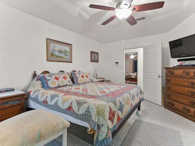 tiled bedroom featuring ceiling fan