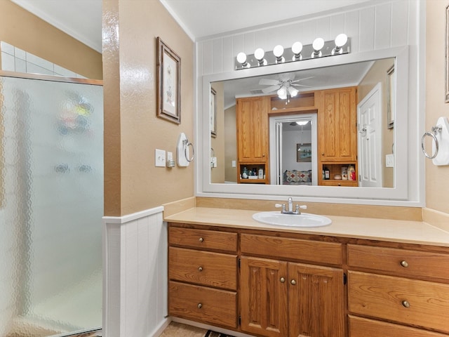 bathroom featuring walk in shower, ceiling fan, and vanity