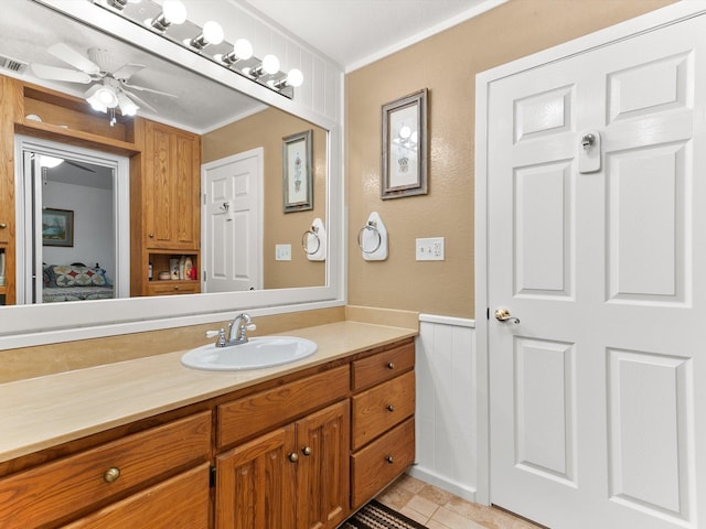 bathroom featuring vanity, ornamental molding, and ceiling fan