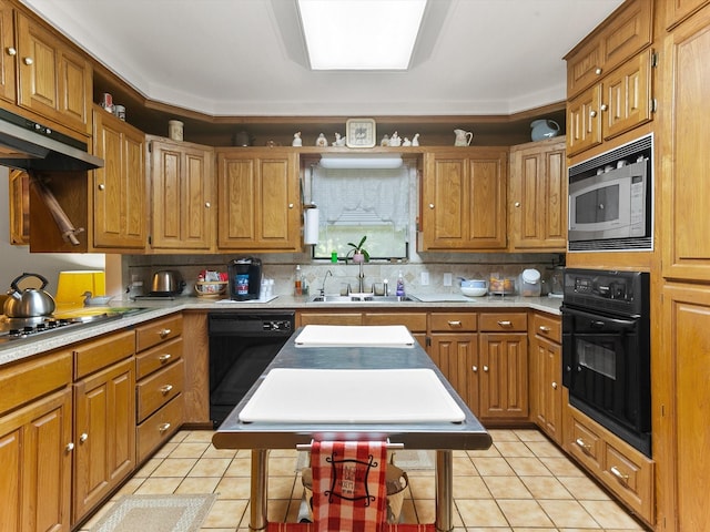 kitchen with sink, light tile patterned floors, backsplash, a center island, and black appliances