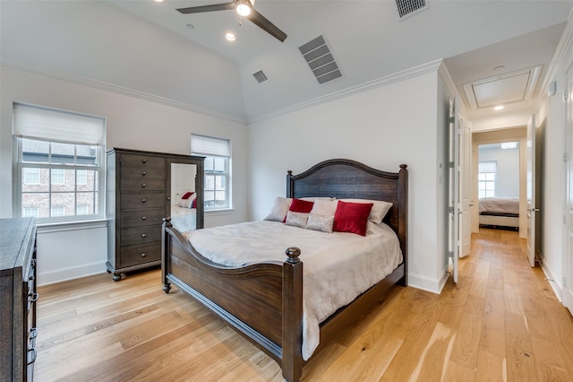 bedroom featuring lofted ceiling, crown molding, light hardwood / wood-style flooring, and ceiling fan