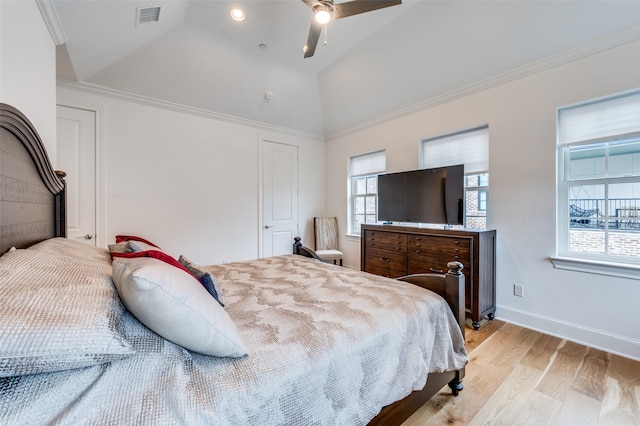 bedroom with ceiling fan, ornamental molding, lofted ceiling, and light hardwood / wood-style flooring