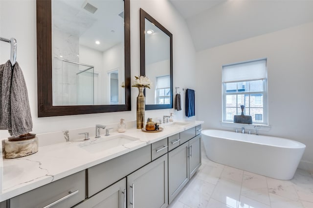 bathroom with vanity, plenty of natural light, and separate shower and tub