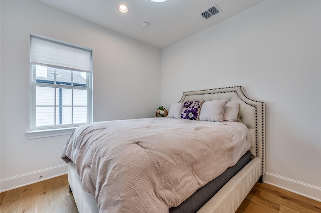 bedroom with hardwood / wood-style floors