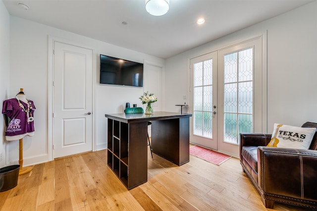 bar featuring light wood-type flooring and french doors