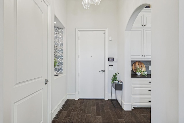 doorway to outside with dark wood-type flooring