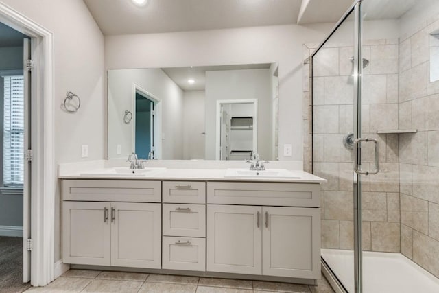 bathroom featuring vanity, tile patterned flooring, and a shower with door