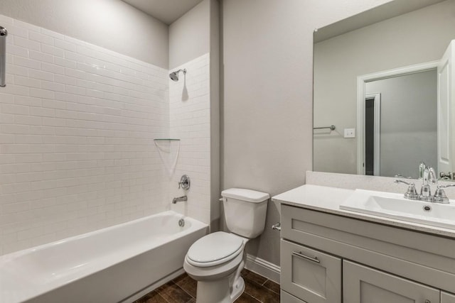 full bathroom featuring vanity, toilet, and tiled shower / bath