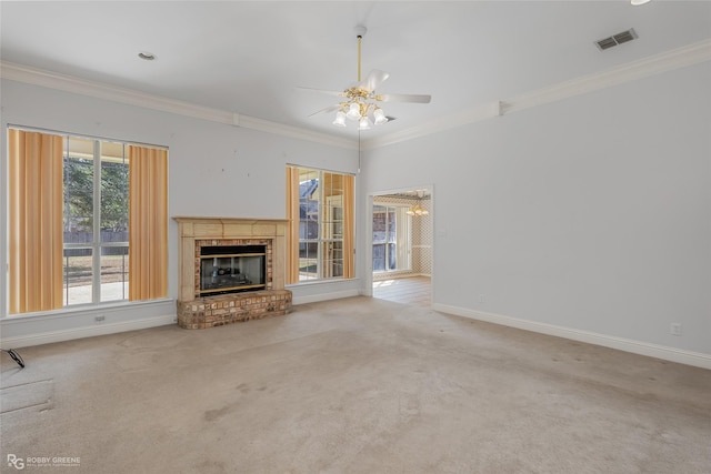 unfurnished living room with crown molding, ceiling fan, carpet flooring, and a brick fireplace