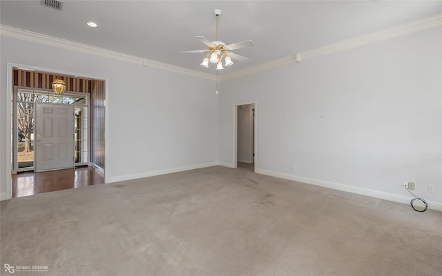 spare room featuring crown molding, ceiling fan, and carpet