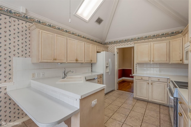 kitchen featuring light tile patterned flooring, lofted ceiling, sink, kitchen peninsula, and stainless steel appliances