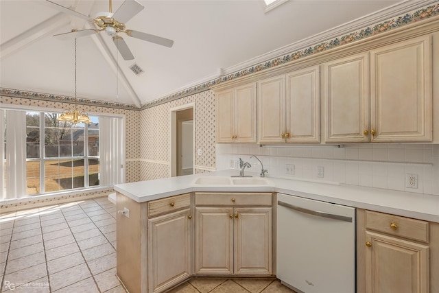 kitchen with lofted ceiling, sink, pendant lighting, dishwasher, and kitchen peninsula