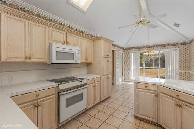 kitchen with vaulted ceiling, pendant lighting, light tile patterned floors, crown molding, and white appliances