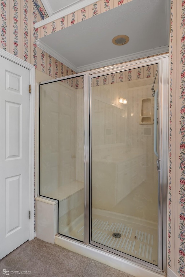 bathroom featuring crown molding and a shower with shower door