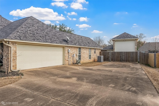 view of property exterior featuring a garage and central air condition unit