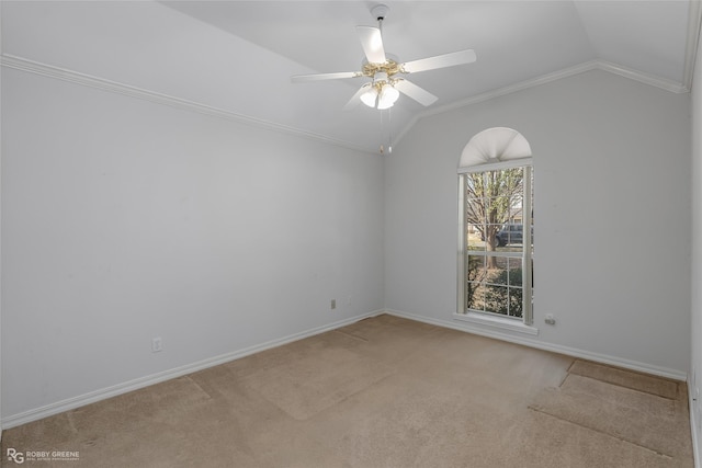 spare room featuring light carpet, crown molding, vaulted ceiling, and ceiling fan