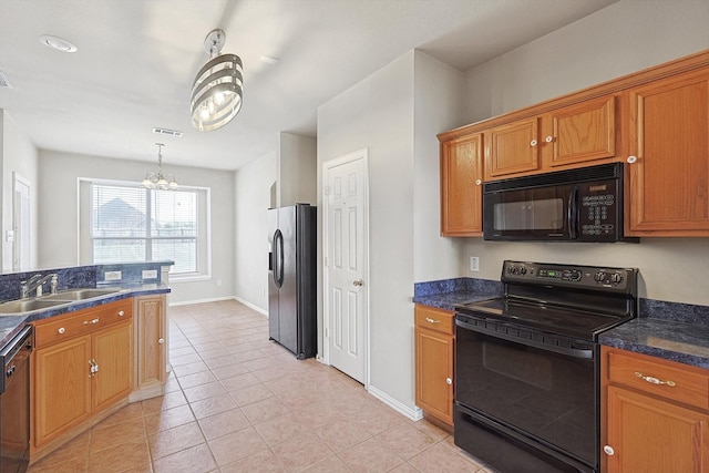 kitchen featuring sink, light tile patterned floors, a notable chandelier, pendant lighting, and black appliances