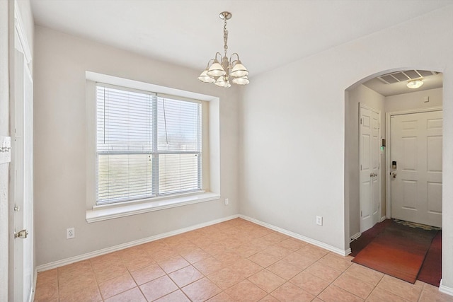 tiled foyer with an inviting chandelier