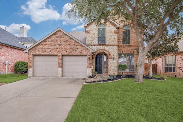 view of property featuring a garage and a front lawn