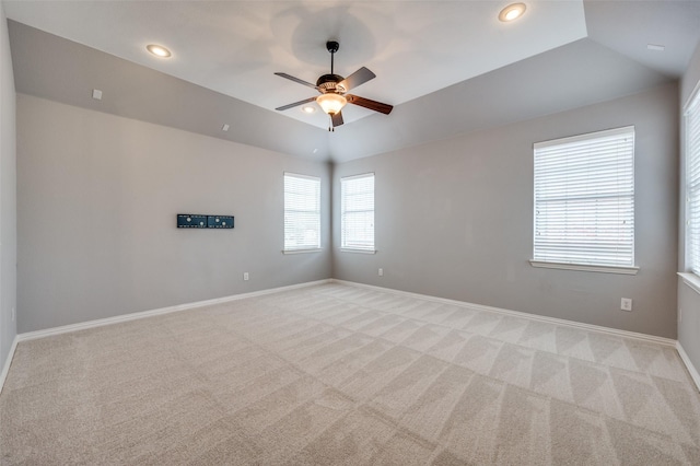 carpeted spare room featuring lofted ceiling and ceiling fan