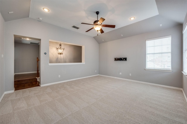 unfurnished room with ceiling fan, lofted ceiling, and light carpet