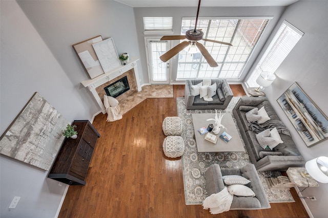 living room with hardwood / wood-style floors, a fireplace, and ceiling fan