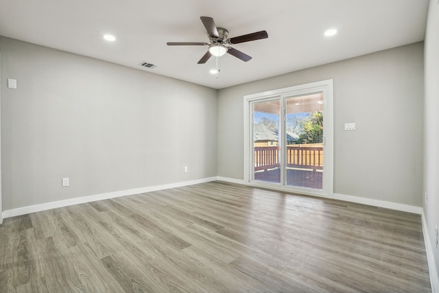 empty room with ceiling fan and light wood-type flooring