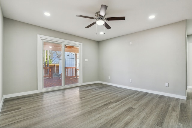 spare room with ceiling fan and light wood-type flooring