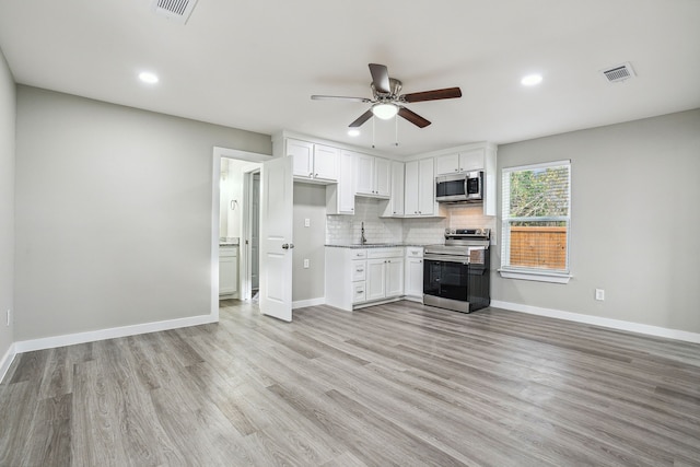 kitchen with tasteful backsplash, appliances with stainless steel finishes, ceiling fan, light hardwood / wood-style floors, and white cabinets