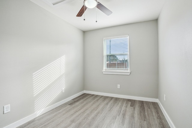 spare room with ceiling fan and light wood-type flooring