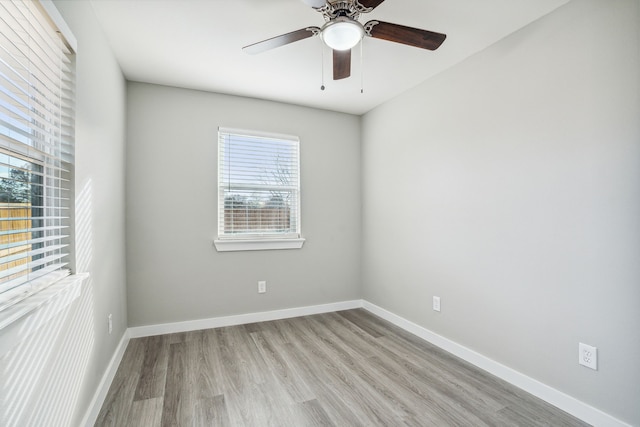 spare room with ceiling fan and light wood-type flooring