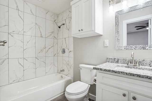 full bathroom with vanity, ceiling fan, tiled shower / bath combo, and toilet