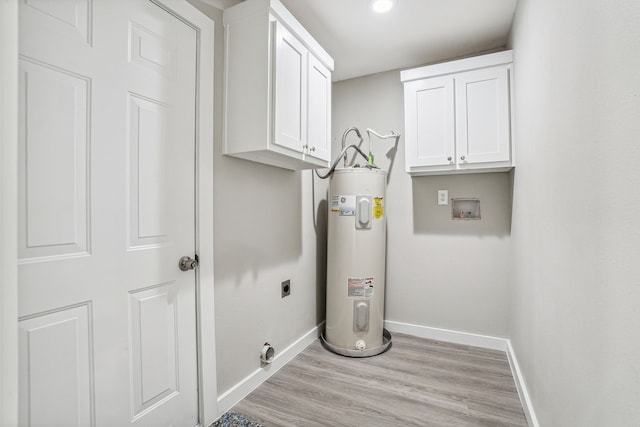 washroom featuring water heater, cabinets, washer hookup, light hardwood / wood-style floors, and electric dryer hookup