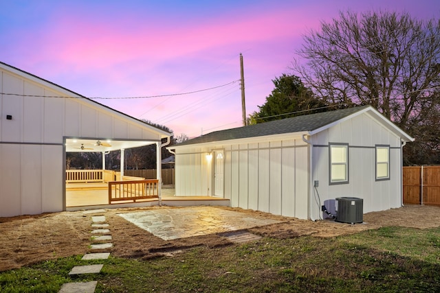 exterior space with a wooden deck, an outbuilding, and central air condition unit