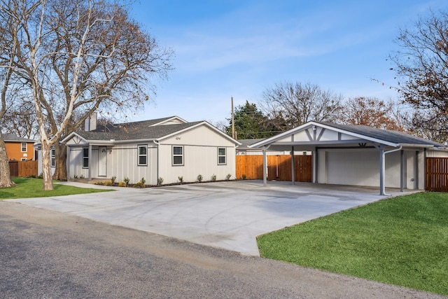 ranch-style home with a carport, a garage, and a front lawn