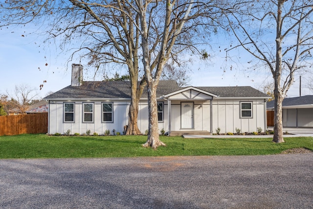 ranch-style home featuring a front yard