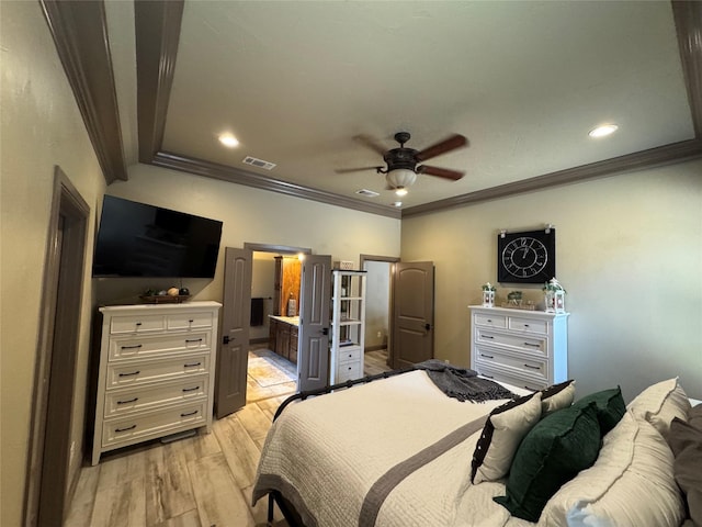 bedroom featuring crown molding, ensuite bathroom, ceiling fan, and light wood-type flooring