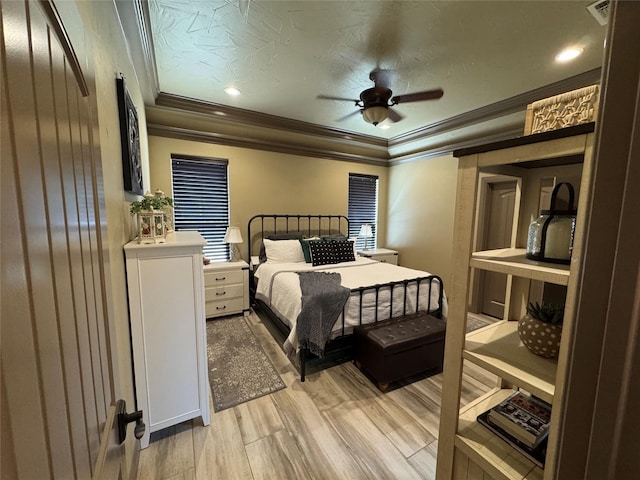 bedroom featuring light hardwood / wood-style flooring, ornamental molding, and ceiling fan