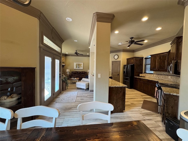 kitchen featuring ornamental molding, electric range, ceiling fan, light hardwood / wood-style floors, and black fridge