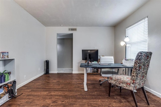 home office with dark hardwood / wood-style flooring