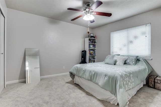 bedroom featuring light carpet and ceiling fan