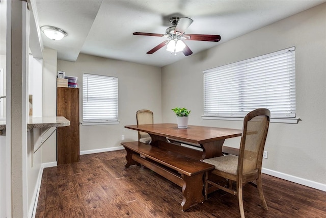 dining area featuring dark wood-type flooring and ceiling fan