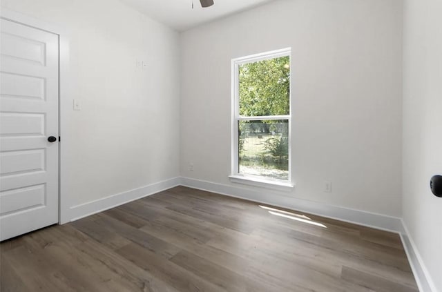 spare room featuring dark hardwood / wood-style flooring and ceiling fan