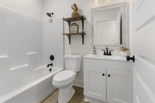 full bathroom with washtub / shower combination, wood-type flooring, toilet, and vanity