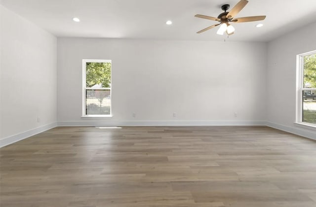 spare room featuring hardwood / wood-style floors and ceiling fan